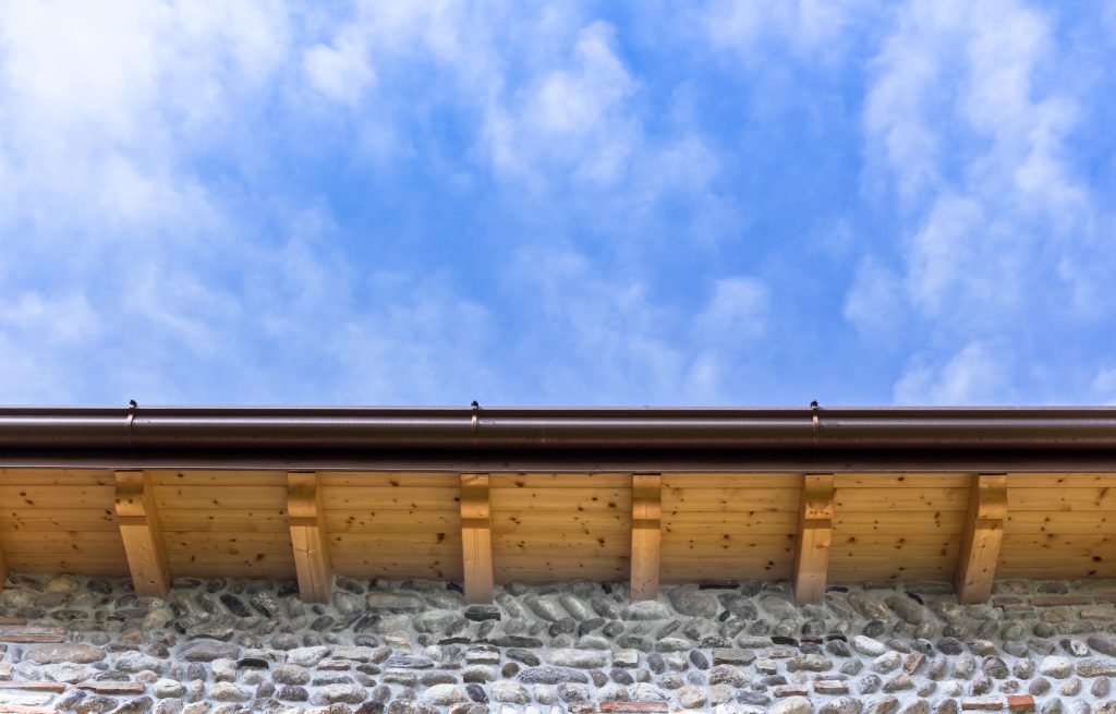 Underside of gutters beneath a blue sky