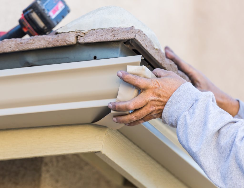 Hand installing the corners of a gutter