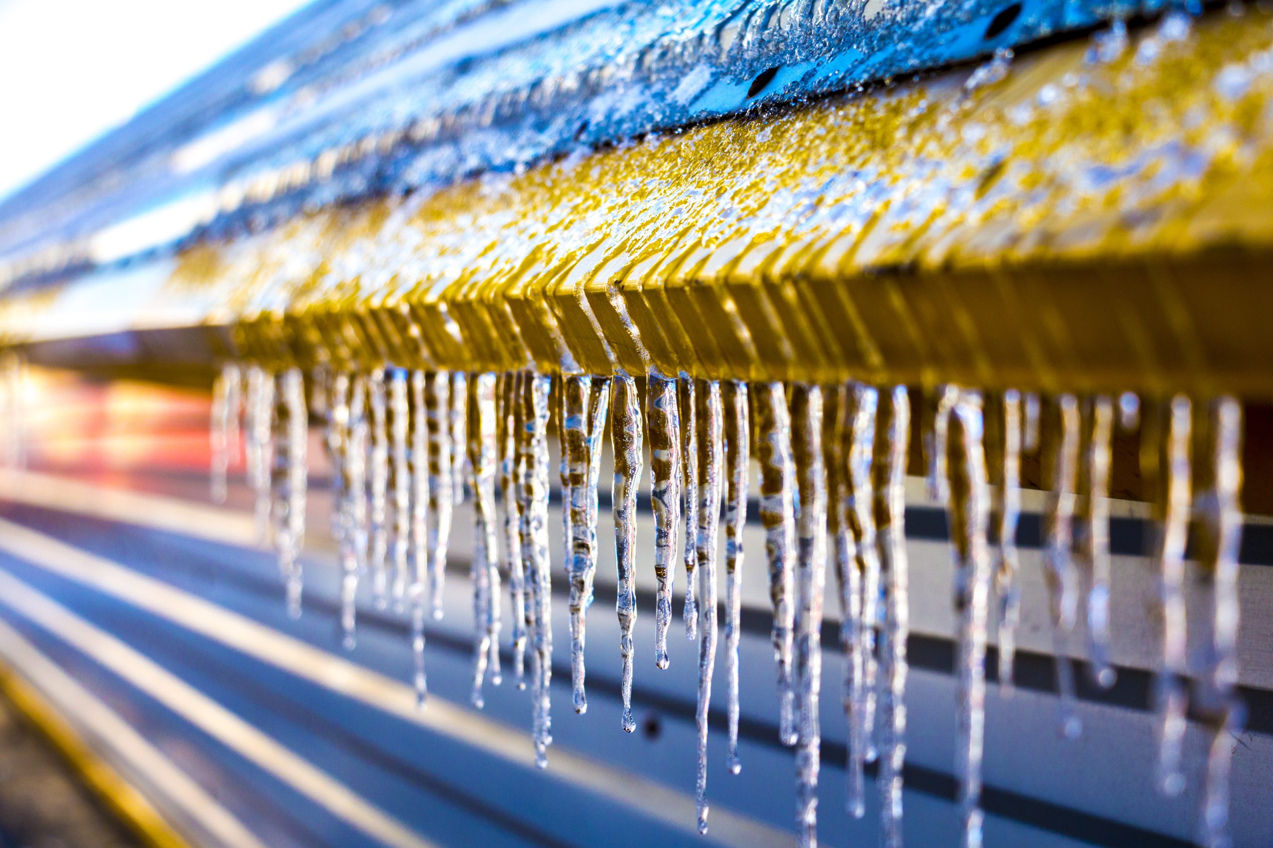 icicles on a yellow roof overhang